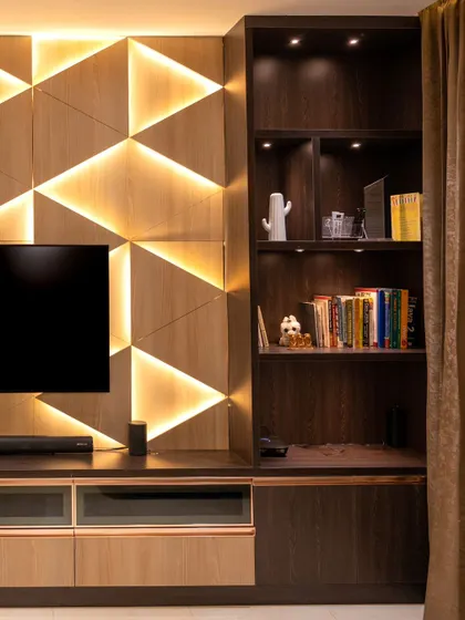 A side view of the TV unit, showing the integrated desk space and shelving, all under the warm glow of our automated lighting.