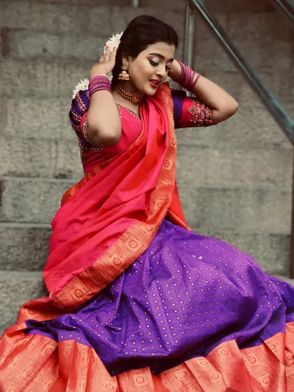 A candid moment on the steps, showing the comfort and grace of our half saree designs.