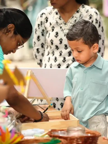 A young guest is completely absorbed in the craft activity, showcasing the engaging and interactive nature of the event.
