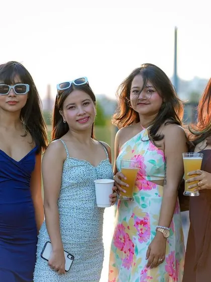 A group of friends posing in the sun, enjoying the daytime vibes of the pool party.