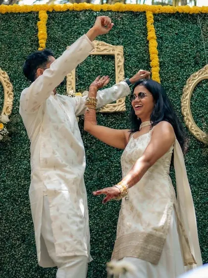Pure joy and celebration during the Haldi. I design spaces that encourage guests to let loose and have fun, resulting in genuine, happy moments like this one.