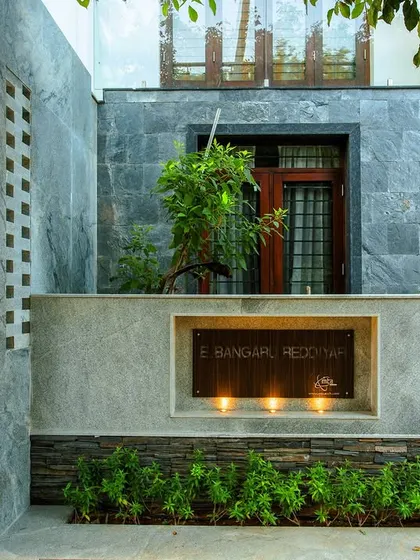 The custom house nameplate is integrated into the modern stone-clad facade, showcasing our attention to even the smallest details.