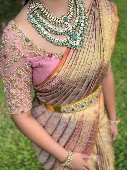 A beautiful client looking radiant in a perfectly draped saree. The drape enhances her silhouette and complements her stunning jewellery.