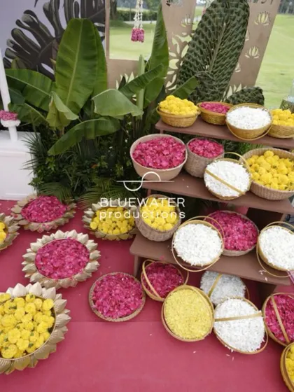 Baskets of fresh flower petals in pink, yellow, and white are ready for the ceremony.
