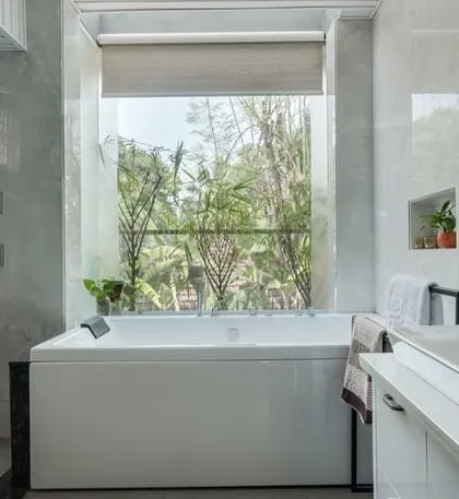 A view of the jacuzzi and the large window, which is the focal point of this bathroom. It’s designed to provide a spa-like experience, connecting you with nature while you relax.