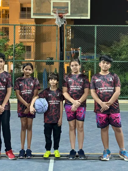 This is our uniform, this is our identity. My mixed-gender U-15 Warriors team stands united and ready for their next basketball match, showcasing their team pride.