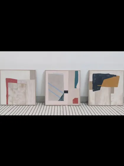 This is a triptych, a set of three paintings designed to be hung together. Each canvas features a unique abstract composition with earthy tones and pops of red and blue, creating a cohesive yet varied art installation.