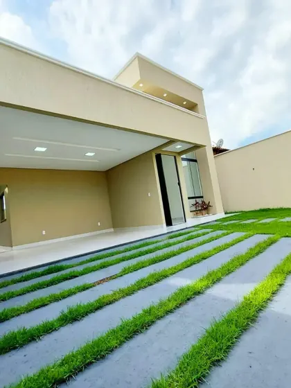 This image showcases a minimalist driveway design with concrete slabs and neat grass lines. This approach is ideal for modern homes, offering a sleek and functional entrance that requires minimal maintenance.