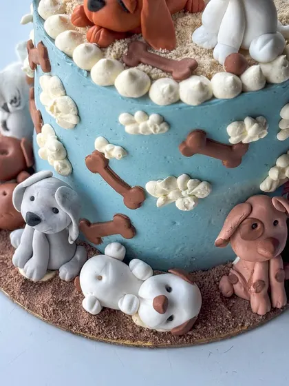 This cake is one of my all-time favorites, made for a true dog lover. It features a variety of handmade fondant dog figurines, each with its own personality, sitting on and around a buttercream cake. It’s a perfect example of how we can turn your passion into a delicious piece of edible art.