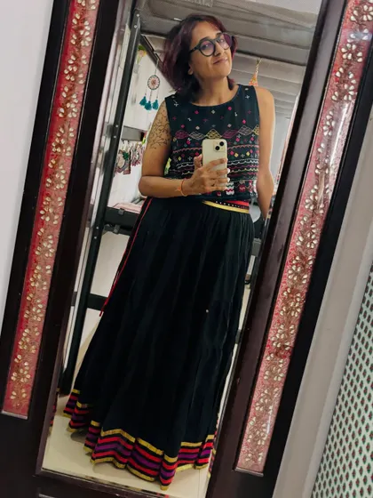 A mirror selfie capturing the beautiful embroidery of my crop top and the colorful border of the skirt.