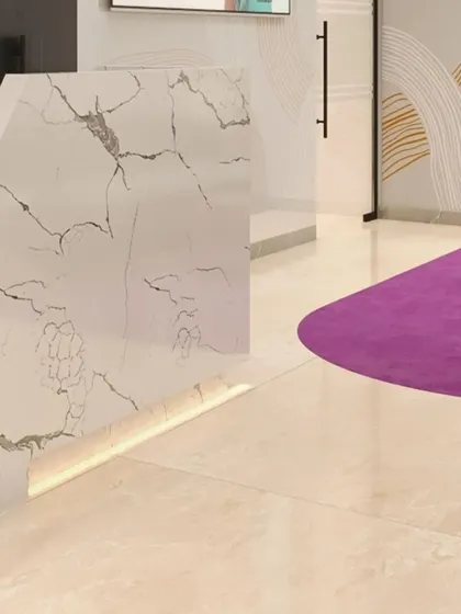 The reception desk, featuring a striking white marble with grey veining and integrated under-counter LED lighting. This detail adds a touch of sophistication to the welcome area.