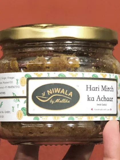 A jar of my Hari Mirch ka Achaar, made with fresh green chilies. This pickle packs a spicy punch and can be made with or without garlic to suit your preference.