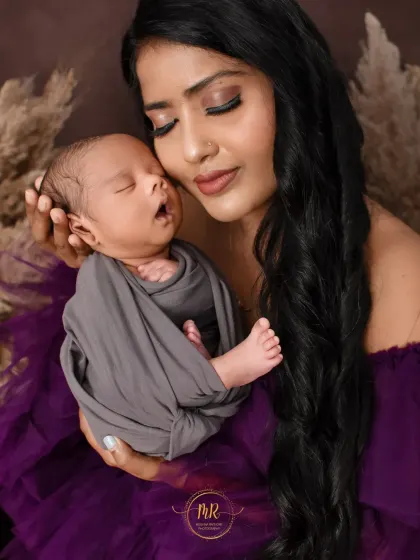 The peaceful expression of a sleeping newborn held lovingly in their mother's arms. These quiet moments are a key part of my newborn photography sessions.