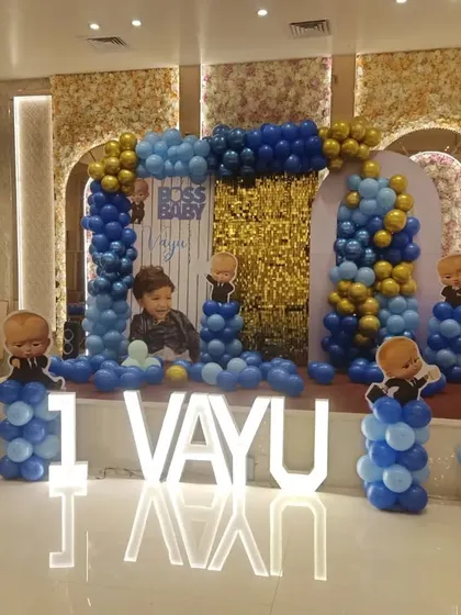 A full view of the Boss Baby themed stage for Vayu's party, showing how the elements come together to fill a large space in a banquet hall.