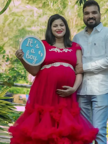 Another wonderful example of a gender reveal, this time for a boy. The couple's proud smiles and the clear sign make for a perfect announcement photo.