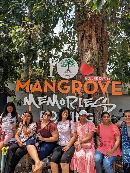 Posing at the "I Love Mangrove Memories" sign in Kerala. These unique ecosystems are a highlight of our trips.