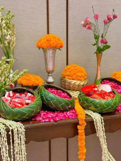 We blended Gujarati and Marwadi aesthetics with Patola prints, gota patti work, heart-themed cushions, and tables laden with marigolds and nostalgic childhood candies.