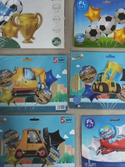 For kids who love vehicles and sports, I have balloon sets featuring soccer balls, trophies, construction vehicles like excavators, and airplanes.