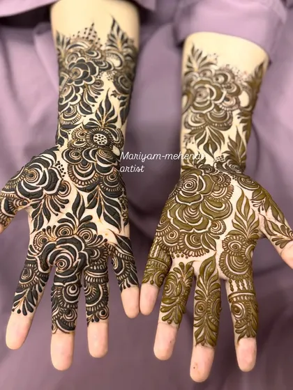 A lovely Dubai floral mehendi, showing the fresh paste on one hand and the design on the other.