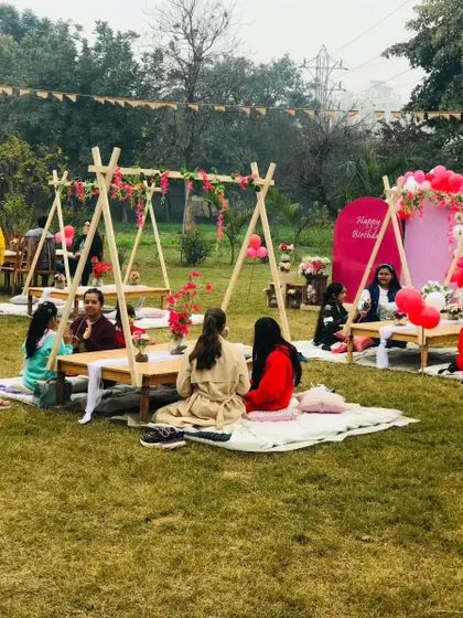 Guests seated at our unique teepee tables, enjoying conversation and the beautiful outdoor setting.