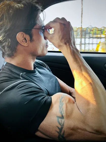 Guns and tattoos. A casual shot showing off my arm size and vascularity, even when relaxed.