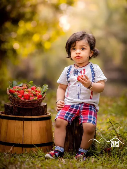 A strawberry treat in the great outdoors. Simple, themed sessions like this are a wonderful way to capture a child enjoying their favorite things.