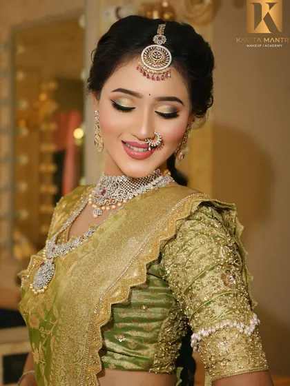 A beautiful South Indian inspired reception look. The green saree is complemented by a soft gold eyeshadow and a radiant, dewy base, creating a fresh and elegant style.