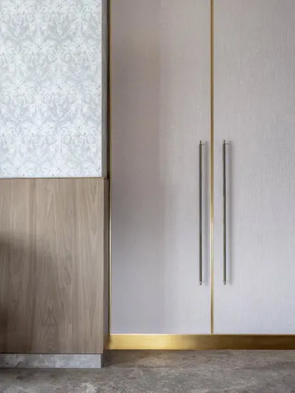 A close-up of the material details in the Skyward Residence. We combined textured wallpaper, warm veneer, and brass accents to create a rich, tactile experience.