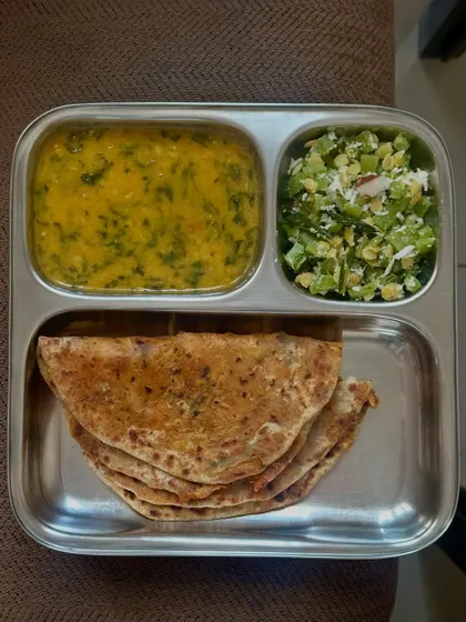A wholesome meal of stuffed paratha with dal methi and a side of sautéed French beans with coconut.