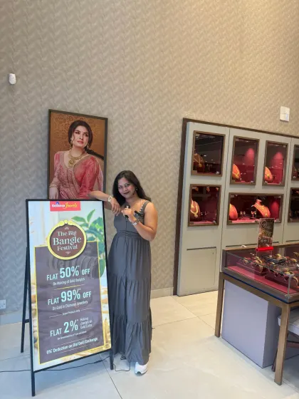 Standing by the promotional banner for the Reliance Jewels event. I help draw attention to the brand's offerings while hosting, seamlessly blending entertainment with marketing.