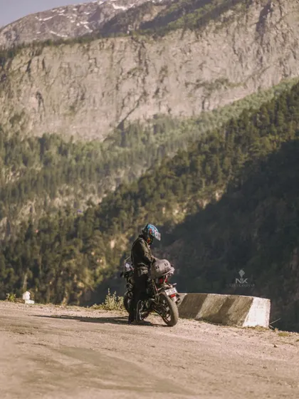 Capturing the solitude and scale of a solo ride. This image emphasizes the rider's connection with the vast, untamed environment during a Himalayan bike expedition.