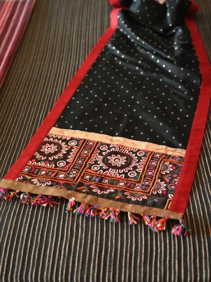 Another view of the reversible runner, highlighting its elegant drape and the vibrant colors of the tribal embroidery.