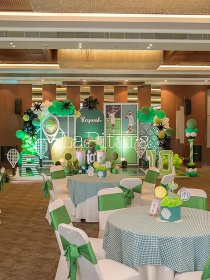 The dining area for the tennis party, with tables and chairs decorated in the theme's green and white color scheme.