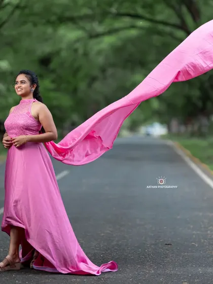 Another beautiful shot of the pink trail gown, showing how it drapes elegantly for a classic maternity portrait.