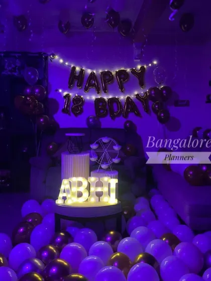 Changing the lighting can completely transform the feel of the decor. Here, the same 18th birthday setup is bathed in a cool purple light, giving it a different, more dynamic party energy.