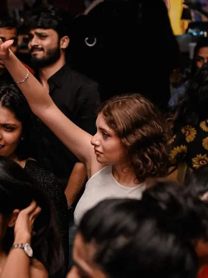 A duplicate of the woman with her hand raised. It's a classic party pose for a reason.