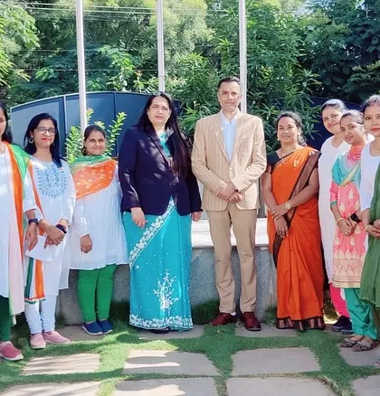 Our esteemed Secretary and Principal pose with the teaching staff, all dressed in patriotic colors for the occasion.