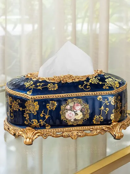 Even everyday items can be luxurious. This Victorian-style tissue box holder, in a deep blue with ornate gold detailing and a floral cameo, elevates a simple utility item into a piece of decor.
