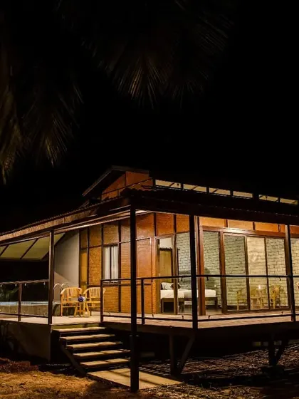 A cottage glows warmly in the twilight, offering a peaceful sanctuary after a day of exploration.
