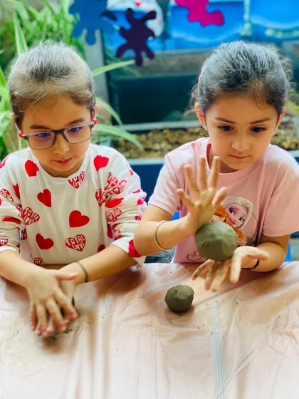 Friends creating side-by-side. Our workshops are a great social activity, allowing kids to share the experience of making art together.