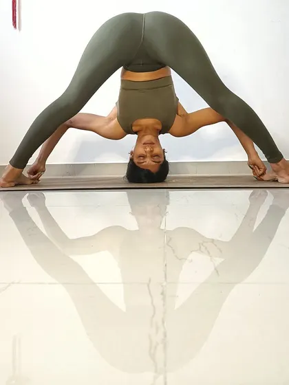 Prasarita Paddottanasana D, my favorite standing forward fold. This variation, where you grab the big toes, helps to lengthen the spine and deepen the hamstring stretch.