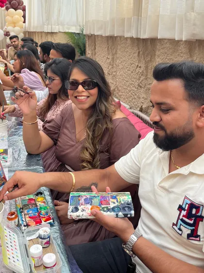 A couple enjoying a creative moment at their baby shower. Painting together is a wonderful way for parents-to-be to celebrate their new beginning.