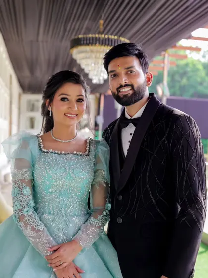 A happy and bright couple portrait from a pre-wedding shoot. Their coordinated outfits and big smiles radiate joy and excitement.