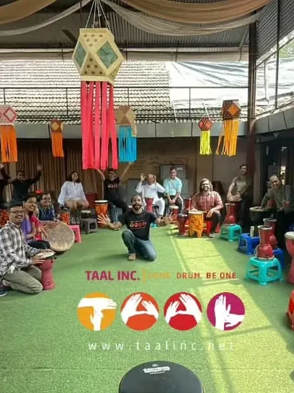 A wide shot of our community drum circle during a festival. The colorful lanterns and the diverse group of people all drumming together create a beautiful picture of celebration and unity.