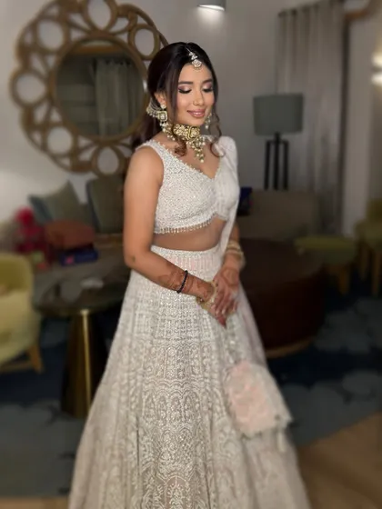The complete look for Vasvi's engagement. The makeup is elegant and timeless, perfectly complementing her beautiful white lehenga.