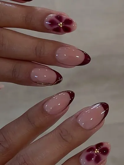 A beautiful and delicate floral design on a French manicure base, showcasing the versatility of blossom gel for creating soft, elegant looks.