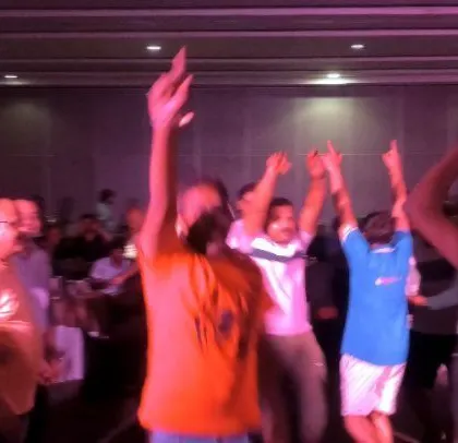 The crowd is all smiles and energy at this corporate party.