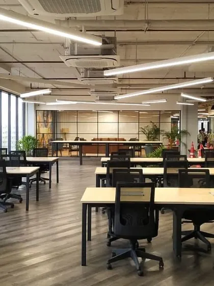 The open-plan hot-desking area at VentureX, with large windows that flood the space with natural light. The layout is designed for flexibility, allowing different users to work comfortably.