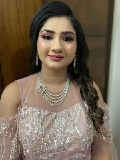 A beautiful pink-themed party makeup look. The glittery pink eyeshadow is the star of the show, perfect for a festive occasion.