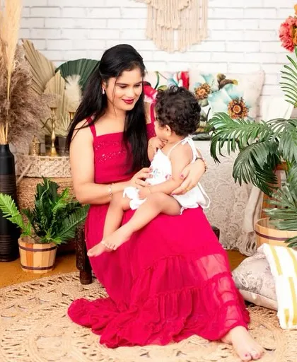 A candid moment of affection. The natural interaction and smiles are what make these mother-daughter portraits so heartwarming.